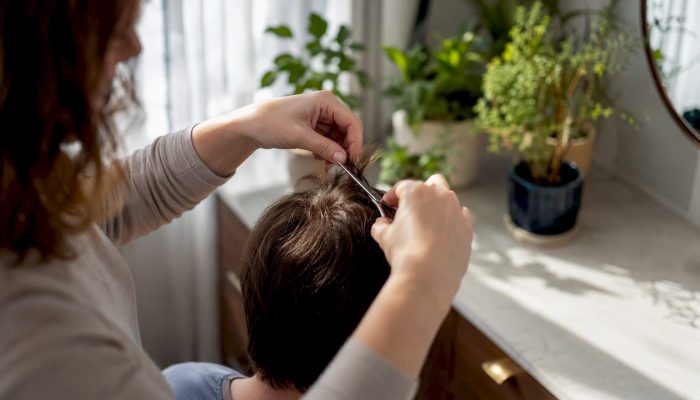 Close-up of hands collecting hair sample